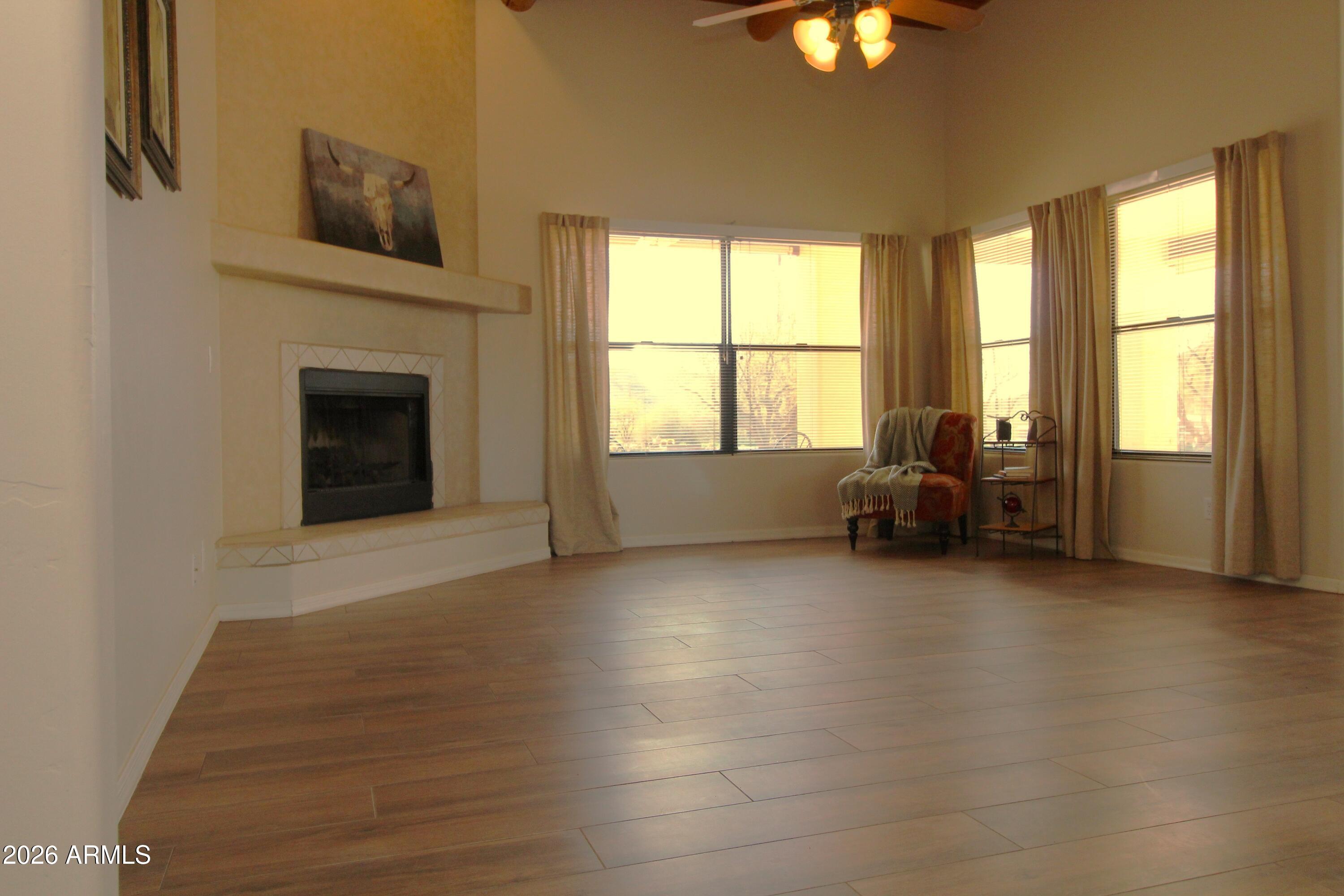 1405 East Circle Mountain Road New River, AZ 85087 - Photo 5 of 40 a view of livingroom with furniture fire place and windows