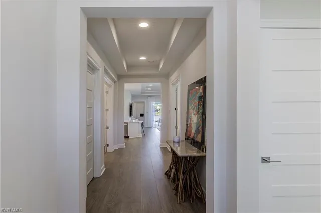 a hallway with white walls and stairs