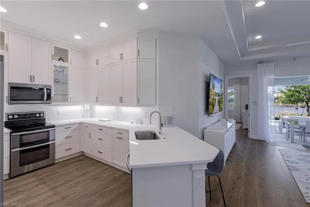 a kitchen with a sink stainless steel appliances and cabinets
