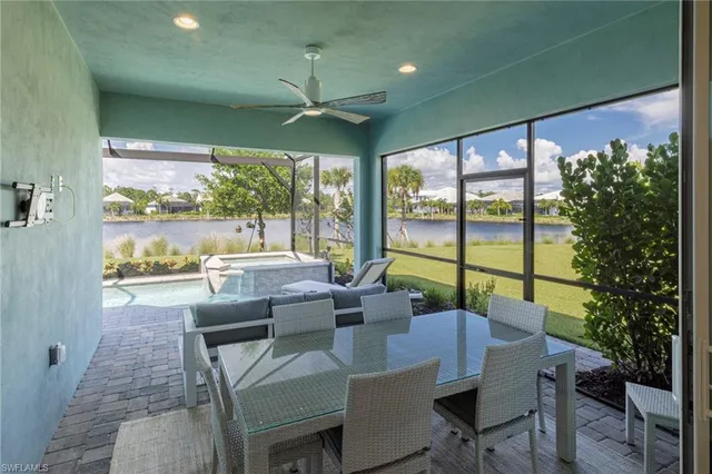 a view of a dining room with furniture large windows and wooden floor