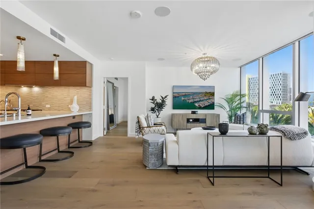 a living room with furniture a large window and a clock