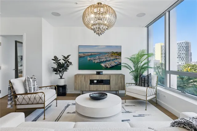 a living room with furniture a fireplace and a large window
