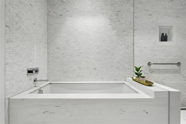 a bathroom with a bathtub and a sink