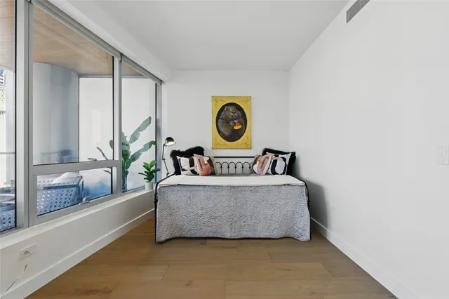 a living room with a couch and a wall painting