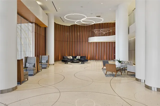 a living room with furniture and a floor to ceiling window