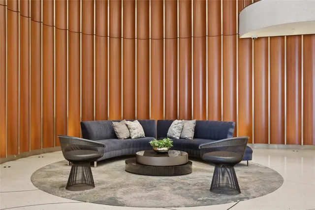 a view of a patio with couches table and chairs and potted plants