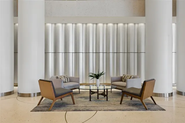 a kitchen with counter top space a sink and living room view