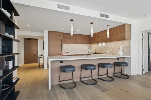 a kitchen with a sink cabinets and wooden floor