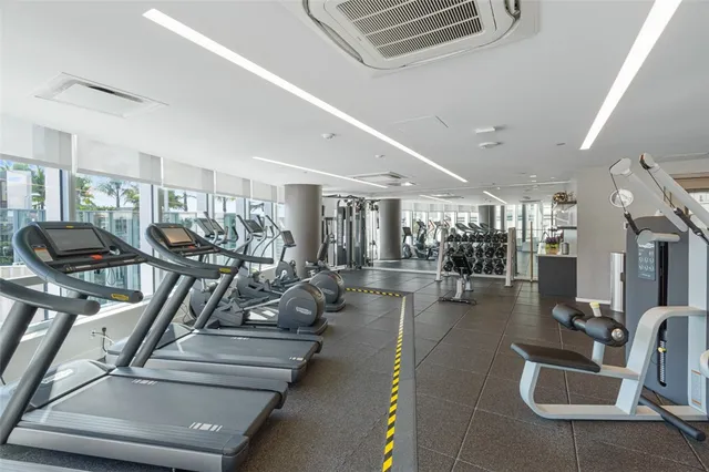 a view of a hallway with wooden floor and cabinet