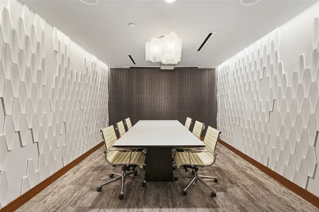 a media room with lots of chairs and a projector screen