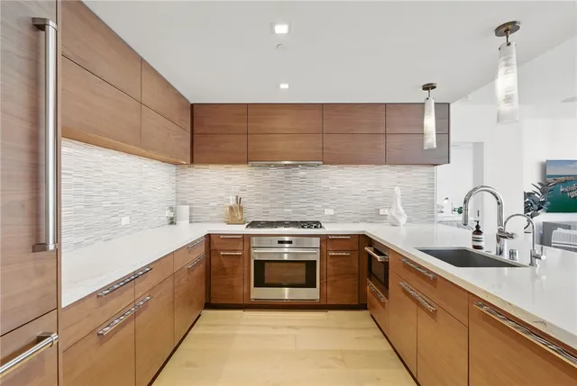 a kitchen with a sink cabinets and stainless steel appliances