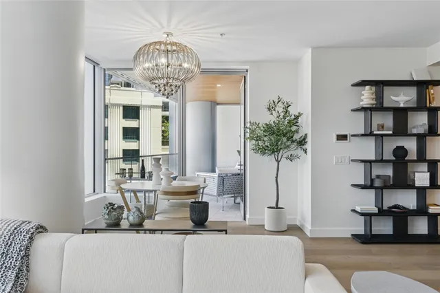 a living room with furniture and a chandelier