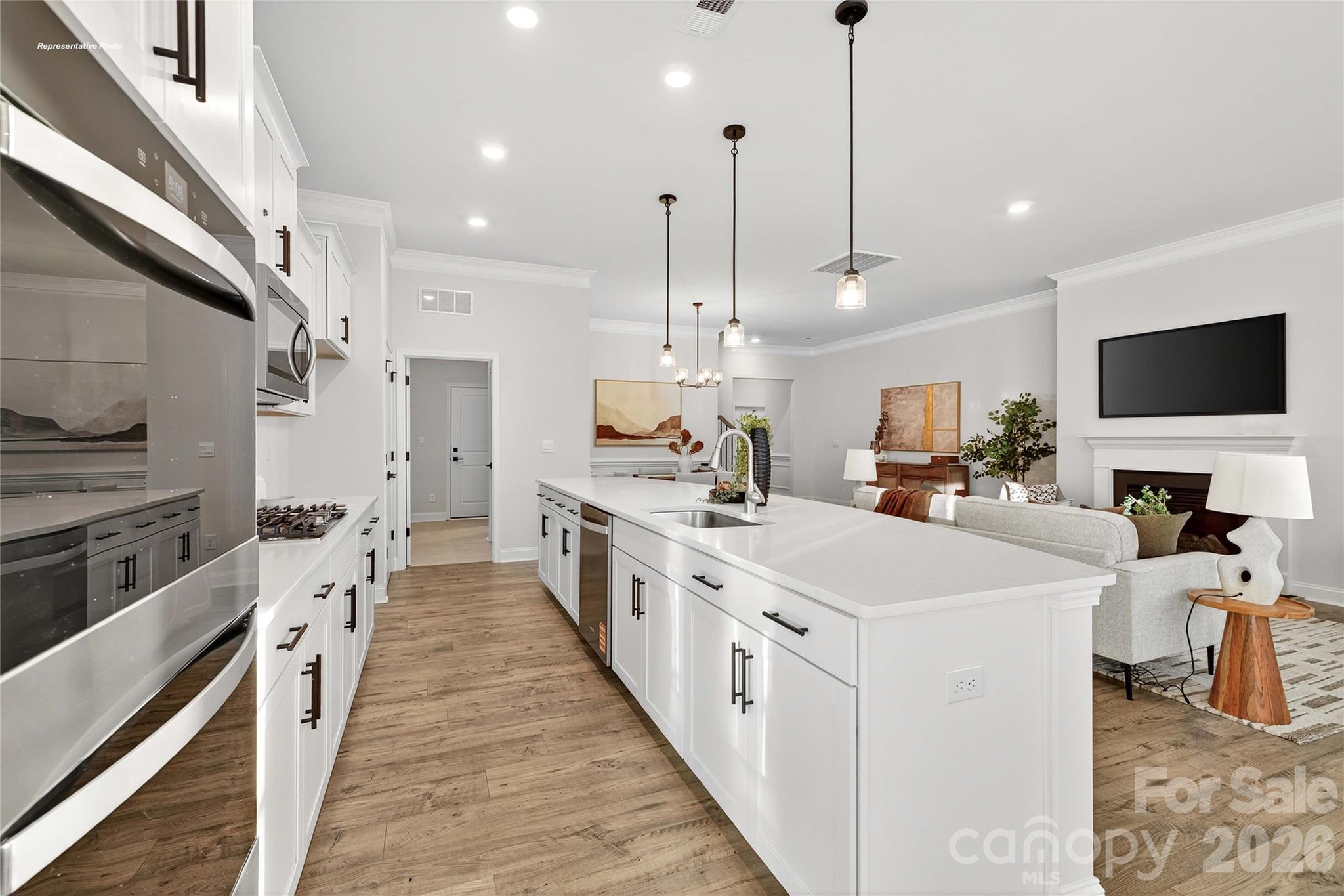 111 Rhuidean Court Troutman, NC 28166 - Photo 11 of 28 a large white kitchen with stainless steel appliances