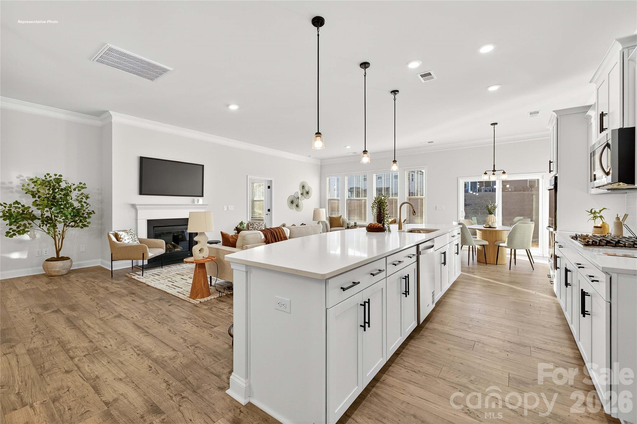 111 Rhuidean Court Troutman, NC 28166 - Photo 12 of 28 a large kitchen with stainless steel appliances kitchen island granite countertop a large counter top and a stove
