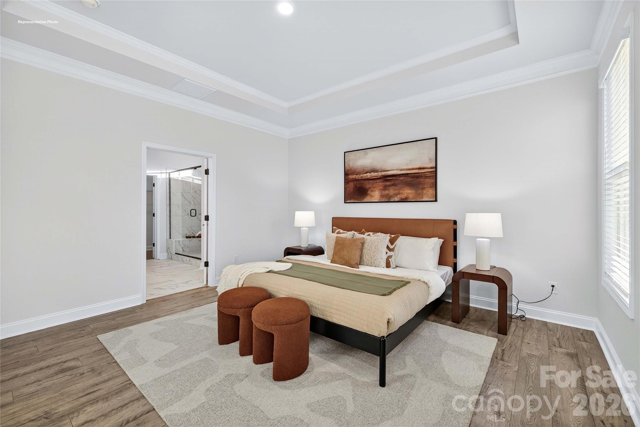 111 Rhuidean Court Troutman, NC 28166 - Photo 15 of 28 a spacious bedroom with a bed and a painting on the wall