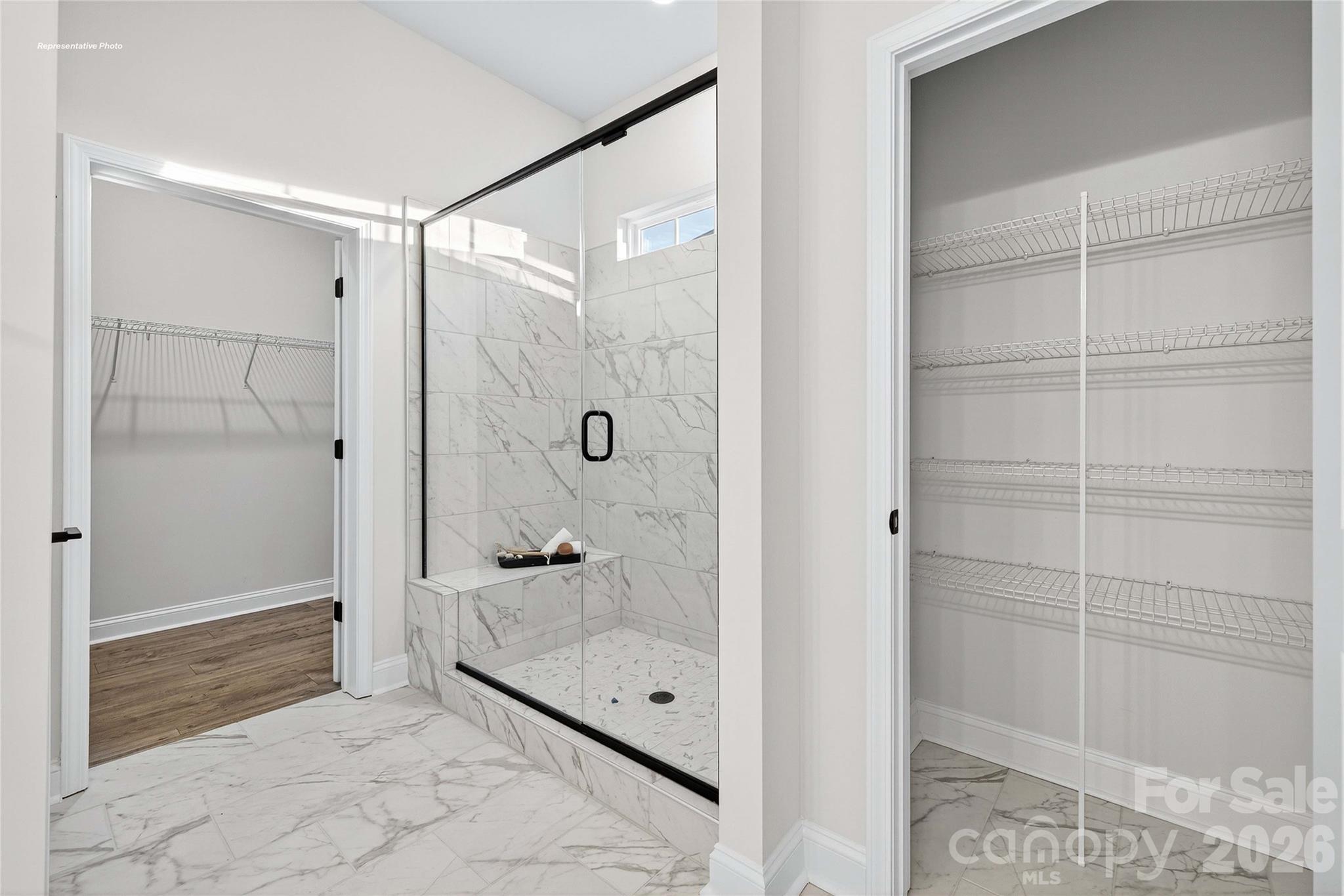 111 Rhuidean Court Troutman, NC 28166 - Photo 18 of 28 a bathroom with a glass shower door and a sink