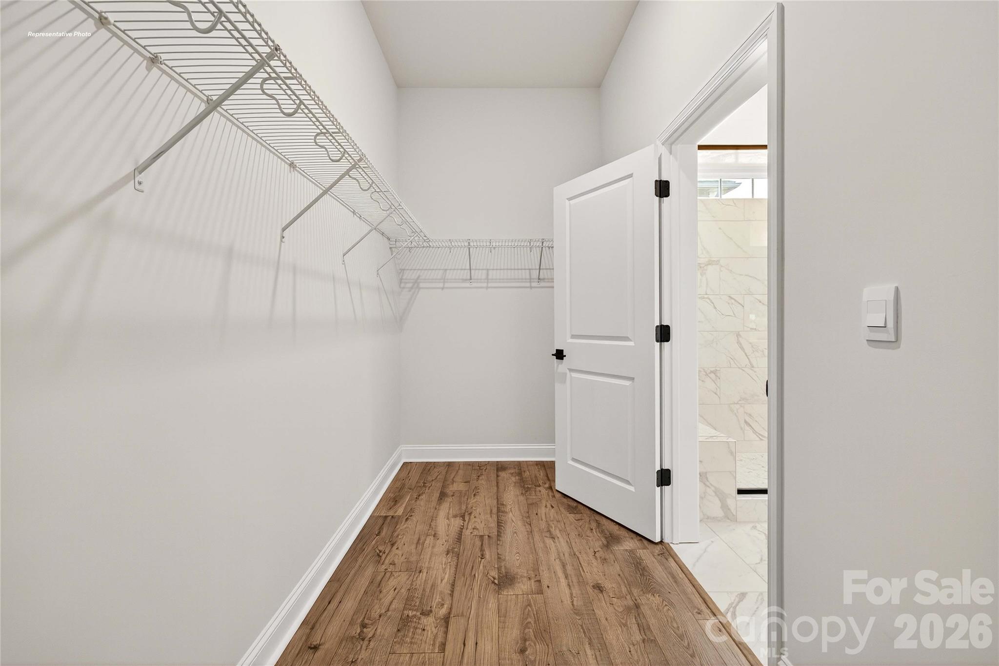 111 Rhuidean Court Troutman, NC 28166 - Photo 20 of 28 a view of a hallway with wooden floor and a bathroom