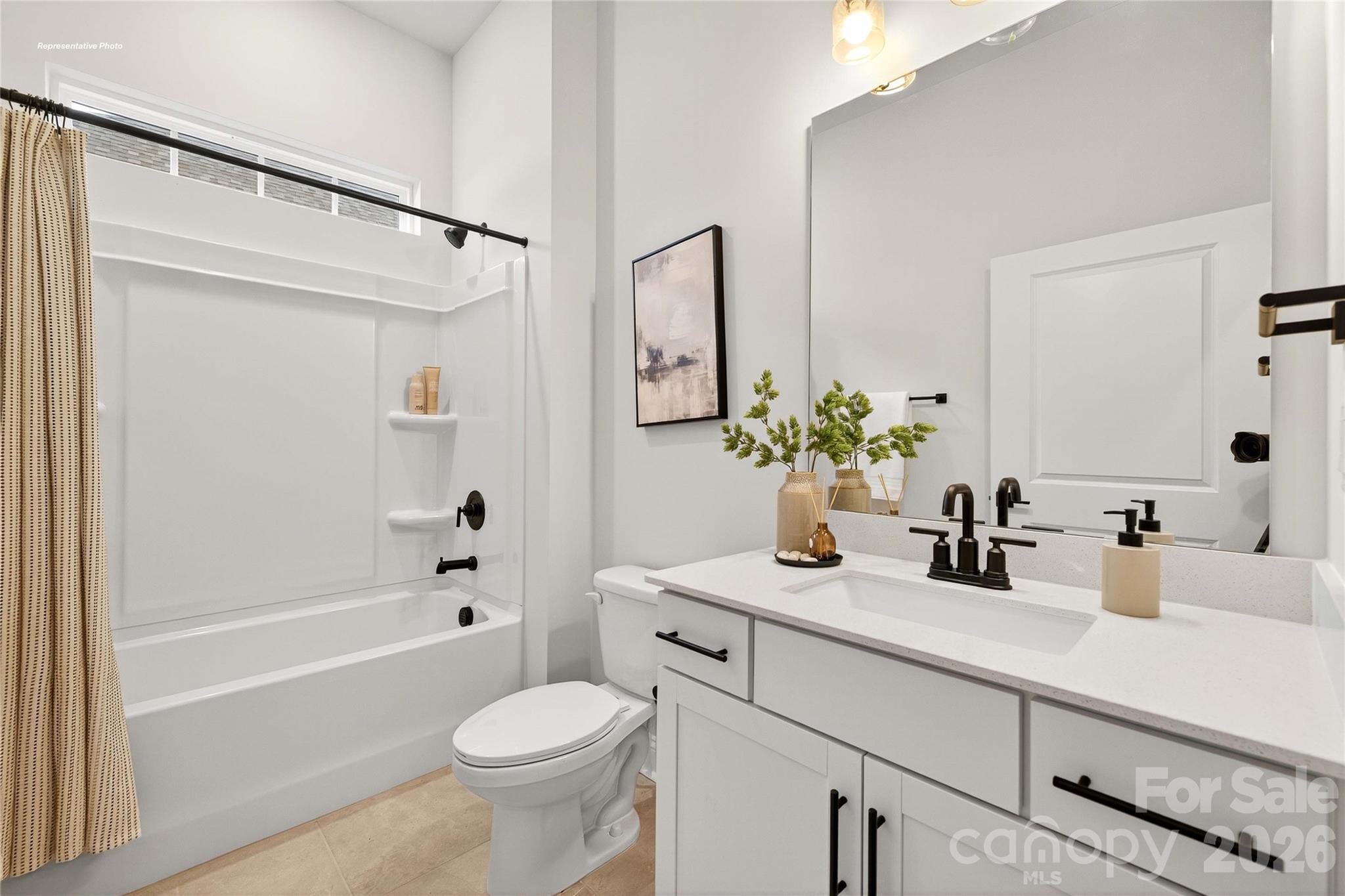 111 Rhuidean Court Troutman, NC 28166 - Photo 21 of 28 a bathroom with a sink a mirror a toilet and a bathtub