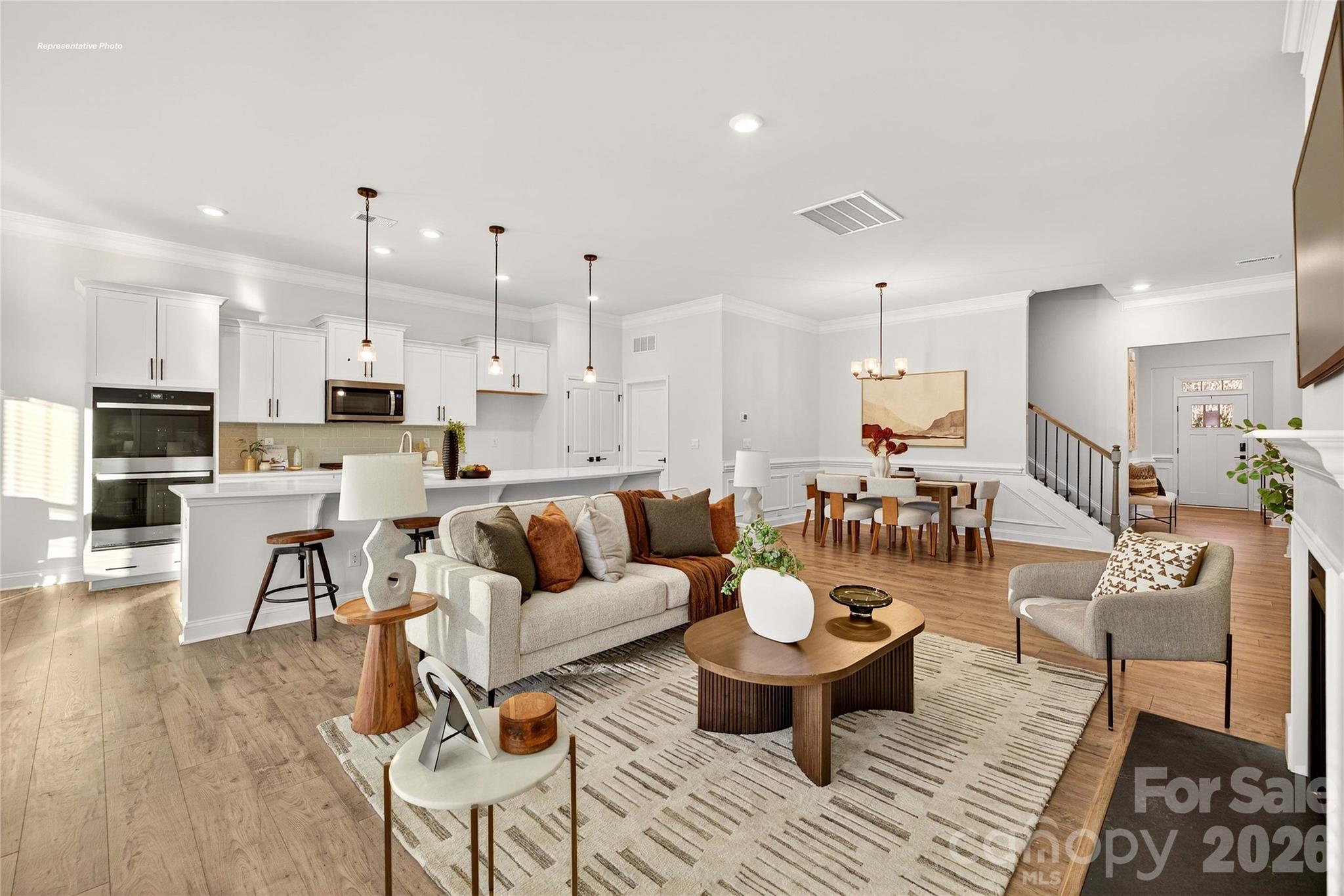 111 Rhuidean Court Troutman, NC 28166 - Photo 7 of 28 a living room with lots of furniture and kitchen view