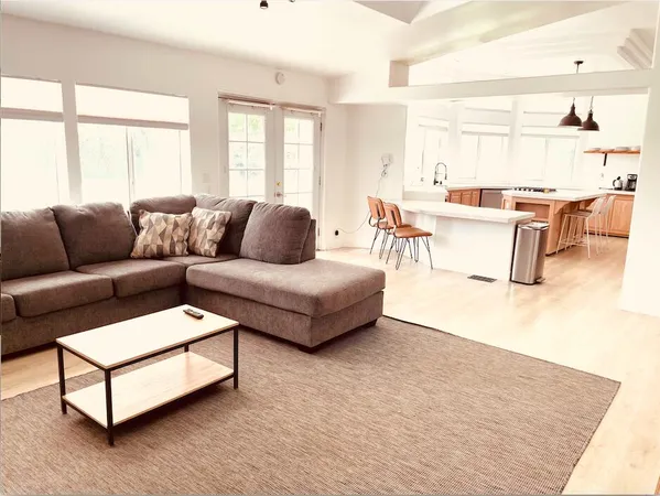 a living room with furniture and a large window