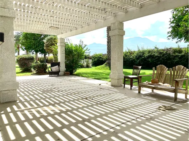 a view of a patio with a table chairs and a patio