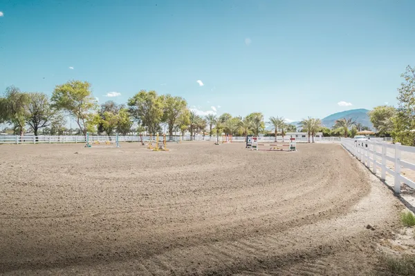 a view of dirt road with a building in the background