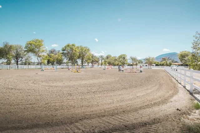 a view of dirt road with a building in the background