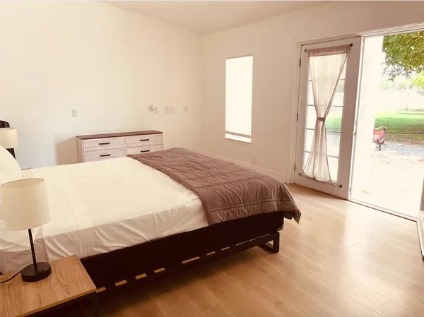 a spacious bedroom with a bed and a window