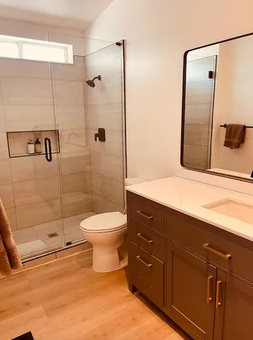 a bathroom with a toilet sink and shower