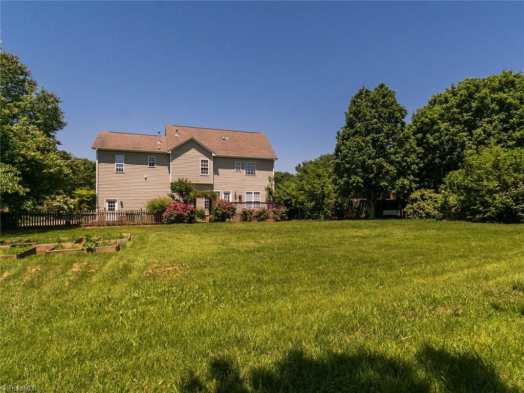 2806 Norwell Court Oak Ridge, NC 27310 - Photo 23 of 30 View of back of the house and the expansive backyard!