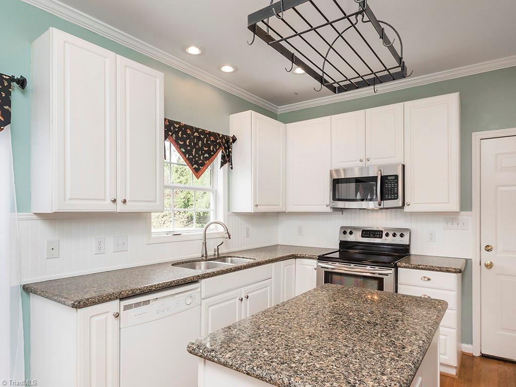 2806 Norwell Court Oak Ridge, NC 27310 - Photo 6 of 30 Beautifully updated kitchen! Quartz countertops, 42" cabinets and some Stainless Steel Appliances!