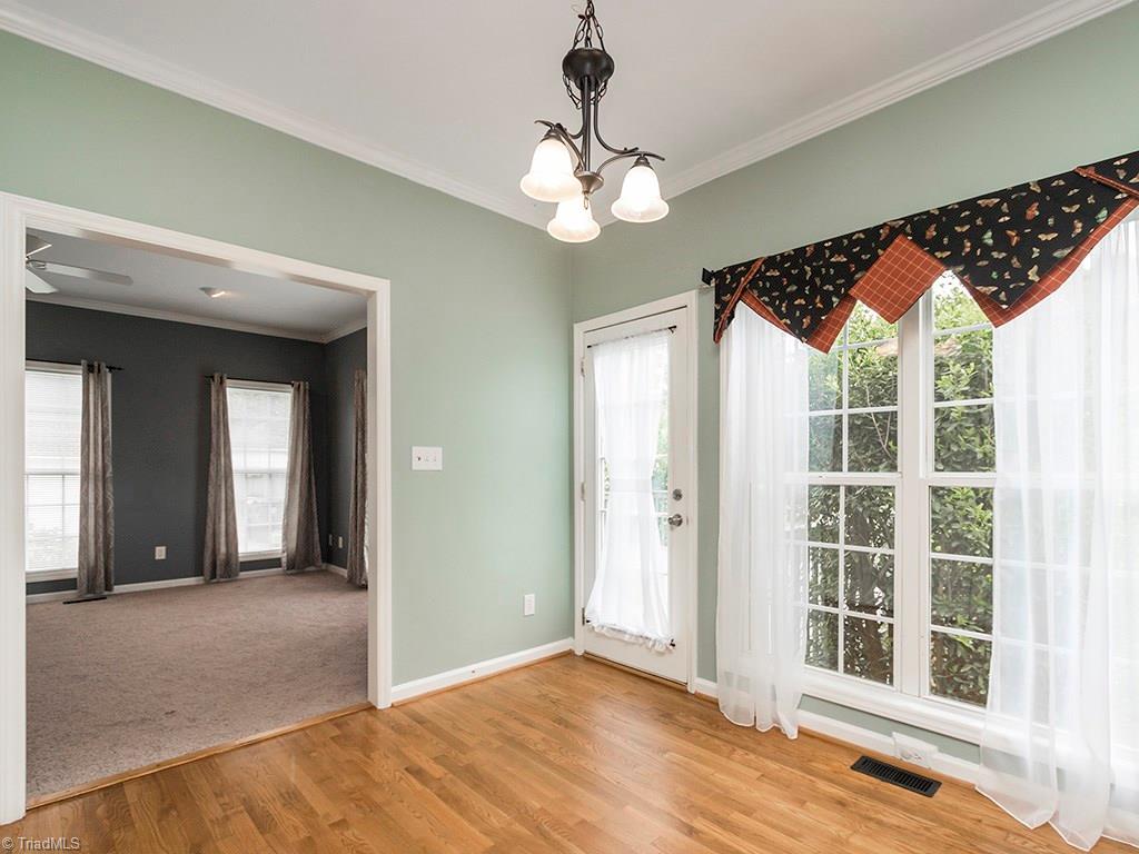 2806 Norwell Court Oak Ridge, NC 27310 - Photo 9 of 30 Eat-in Kitchen with Breakfast area and large window. Walk right out onto the deck and enjoy the private backyard!