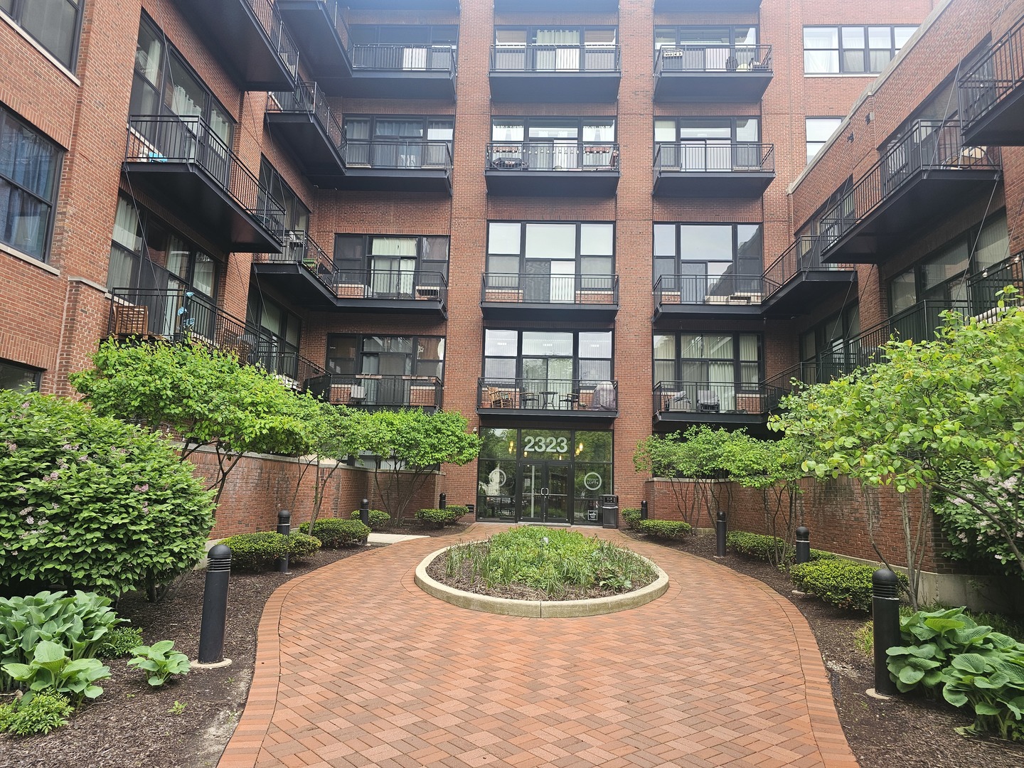 2323 West Pershing Road, Unit 128 Chicago, IL 60609 - Photo 3 of 9 a view of a brick building next to a yard