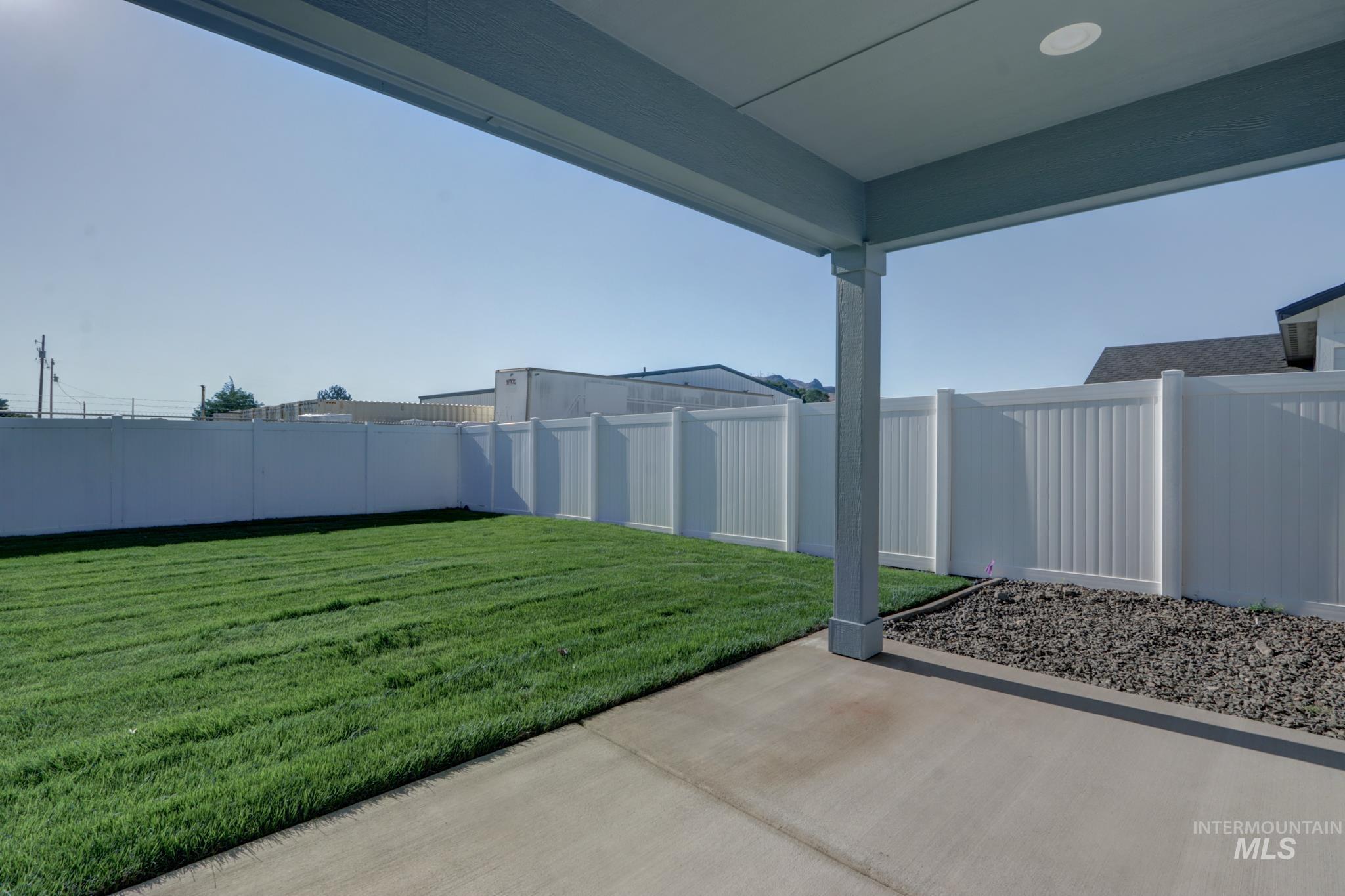 848 North 5th Street Nyssa, OR 97913 - Photo 42 of 49 Covered concrete patio with recessed lighting, bordered by a gravel landscaping strip