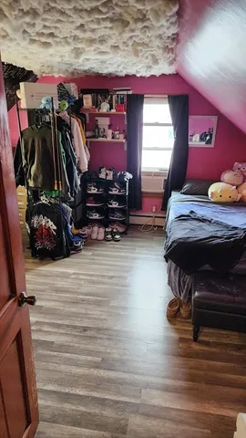 a dining room with furniture a chandelier and wooden floor