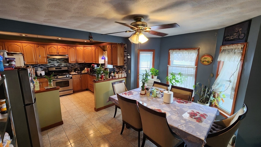 14 Valley Avenue Lynn, MA 01902 - Photo 15 of 16 a dining room with furniture a chandelier and wooden floor