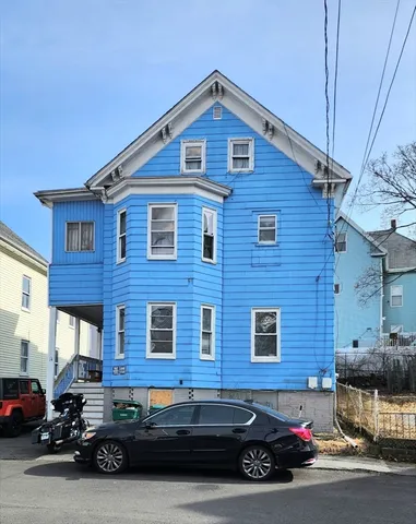 a car parked in front of a brick building