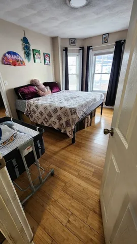 a bedroom with a bed and window