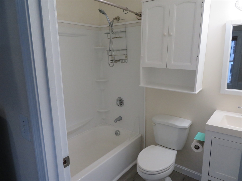 160 High Street, Unit 3 Wareham, MA 02571 - Photo 4 of 8 a white toilet sitting next to a bath tub