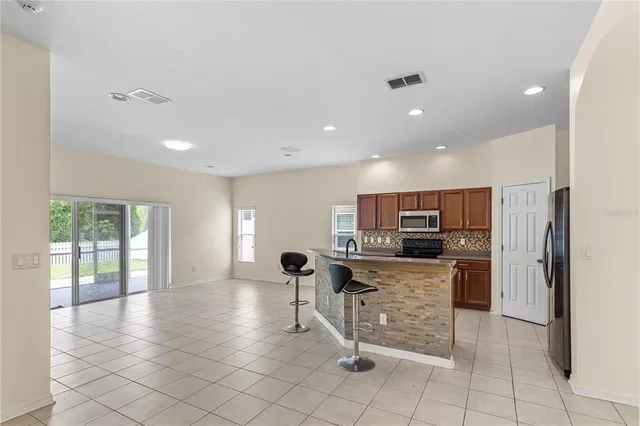 a kitchen with stainless steel appliances a refrigerator and a stove top oven