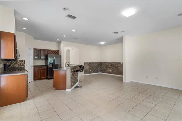a view of kitchen with furniture and refrigerator