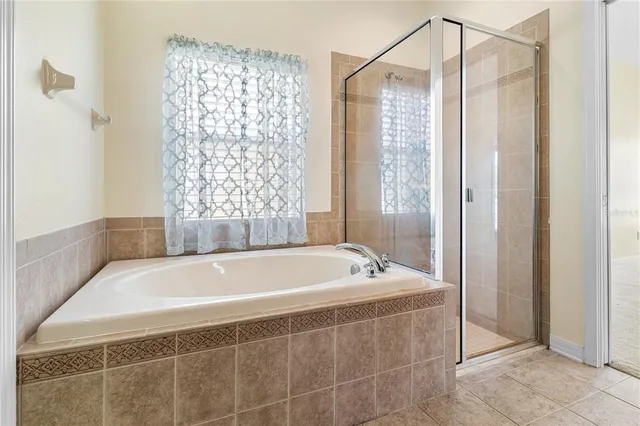 a bathroom with a tub and a shower