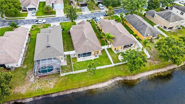 an aerial view of residential houses with outdoor space and swimming pool