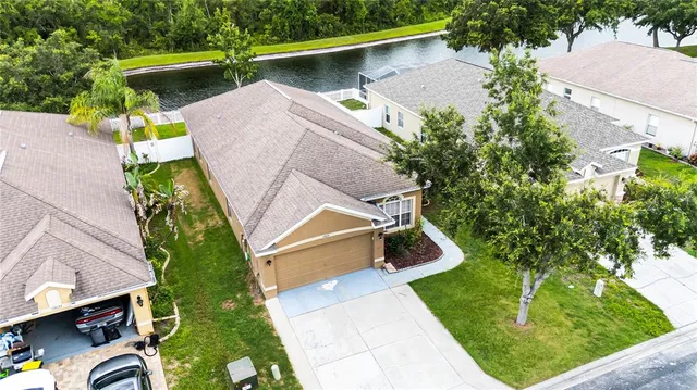 an aerial view of a house with a yard