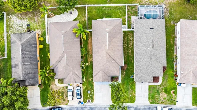 aerial view of a house with a yard and plants