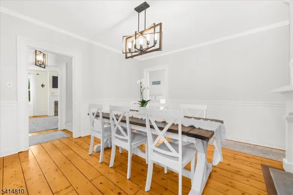 a view of a dining room with furniture and a chandelier