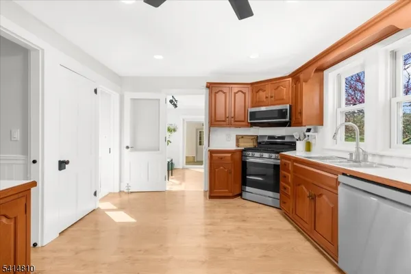 a kitchen with stainless steel appliances granite countertop a refrigerator and a stove top oven
