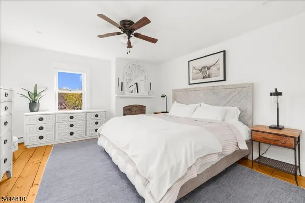 a large white bed in a white bedroom