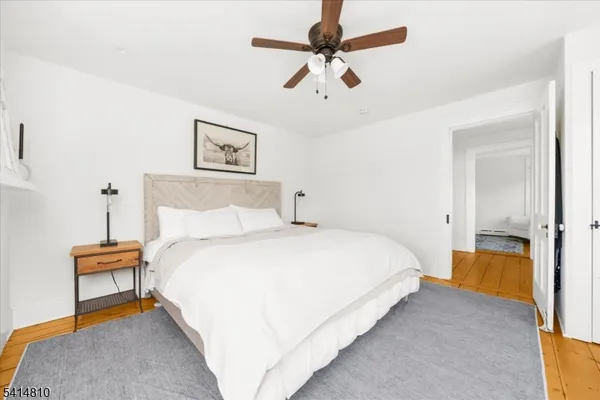 a bedroom with a bed and a painting on the wall