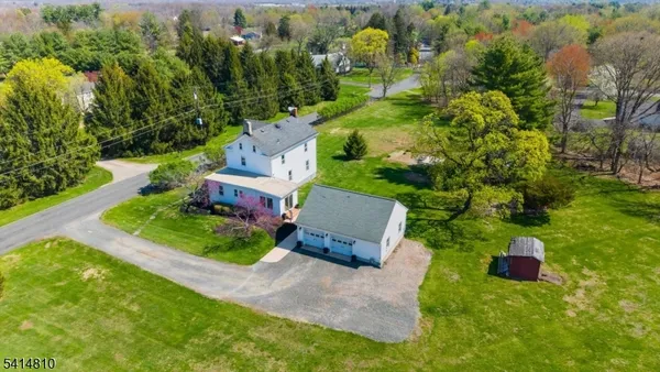 an aerial view of a house with a garden and trees